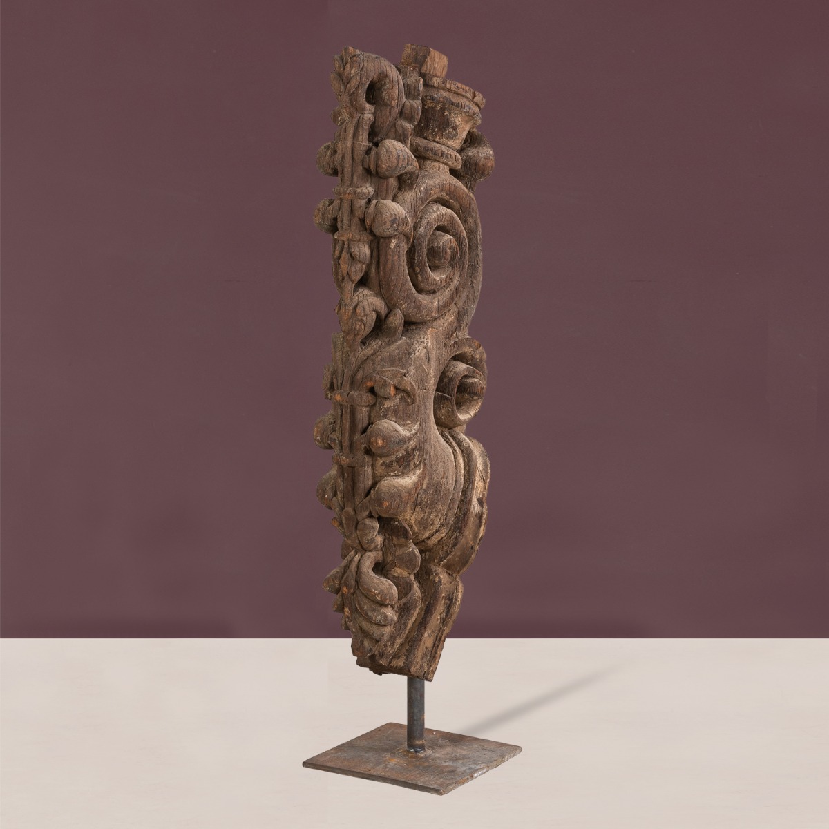 Handcrafted wooden bracket on stand highlighting carved detailing